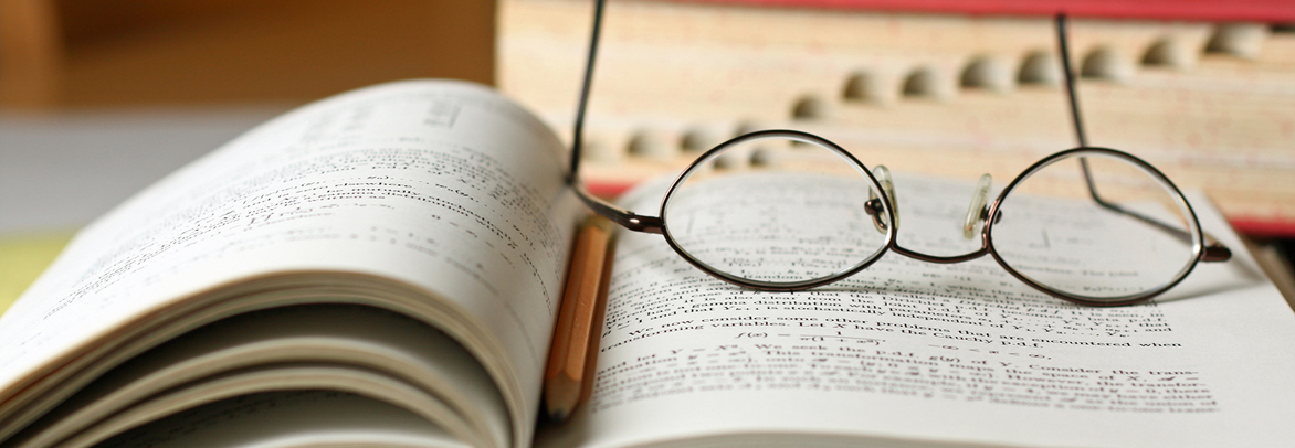 Books on Table with Glasses